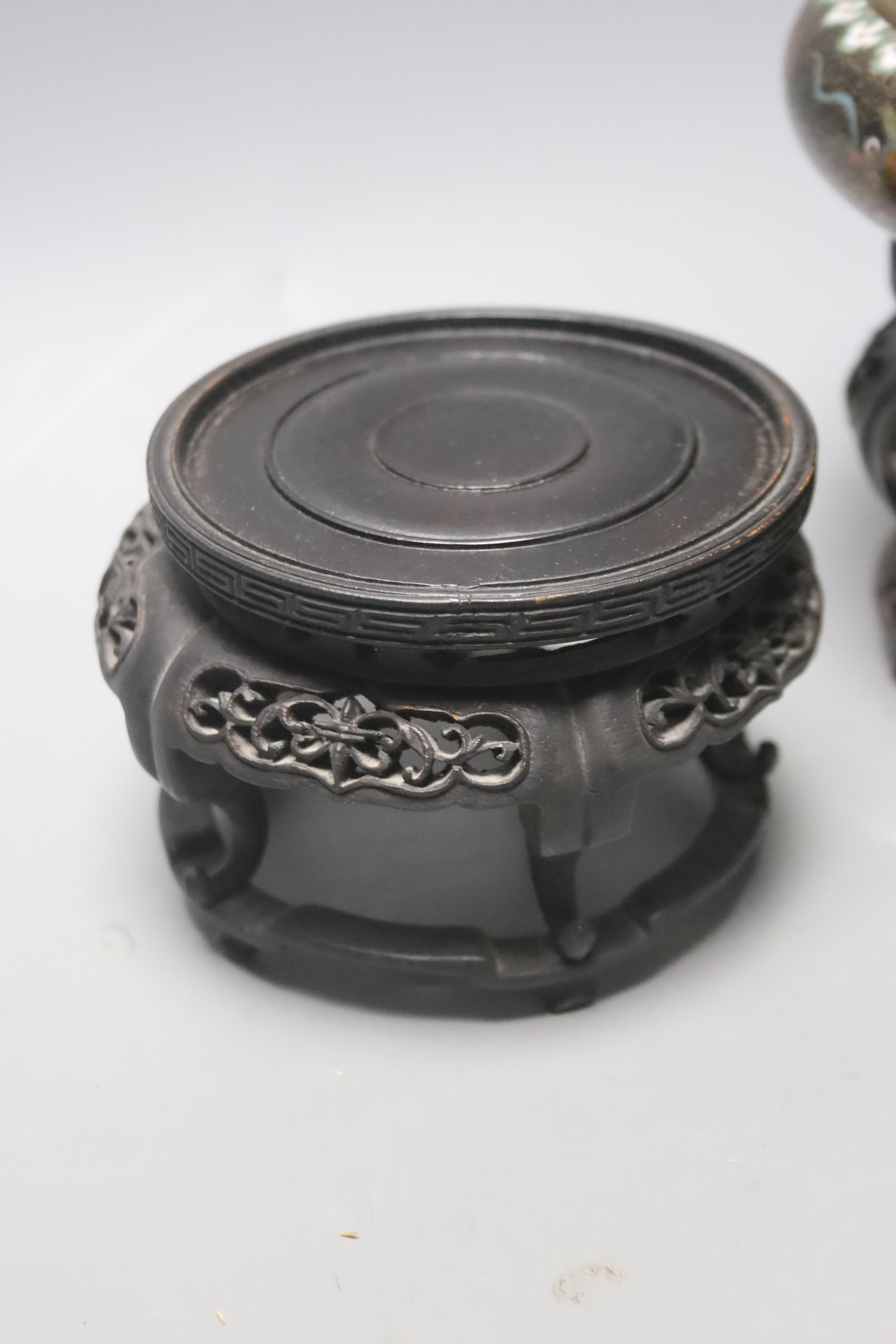A pair of Chinese cloisonne enamel small 'dragon' bowls, wood stands